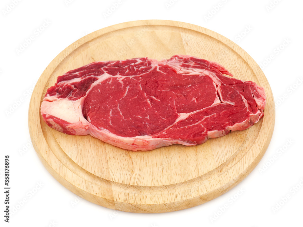 Raw steak on wooden plate isolated on white background Raw steak on wooden plate isolated on white background