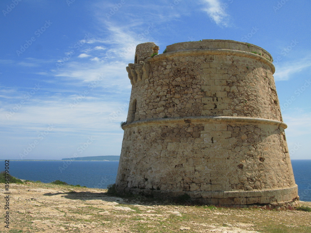 The defence tower in Cap de Barbaria, Formentera island, Spain - blue sky with some light clouds