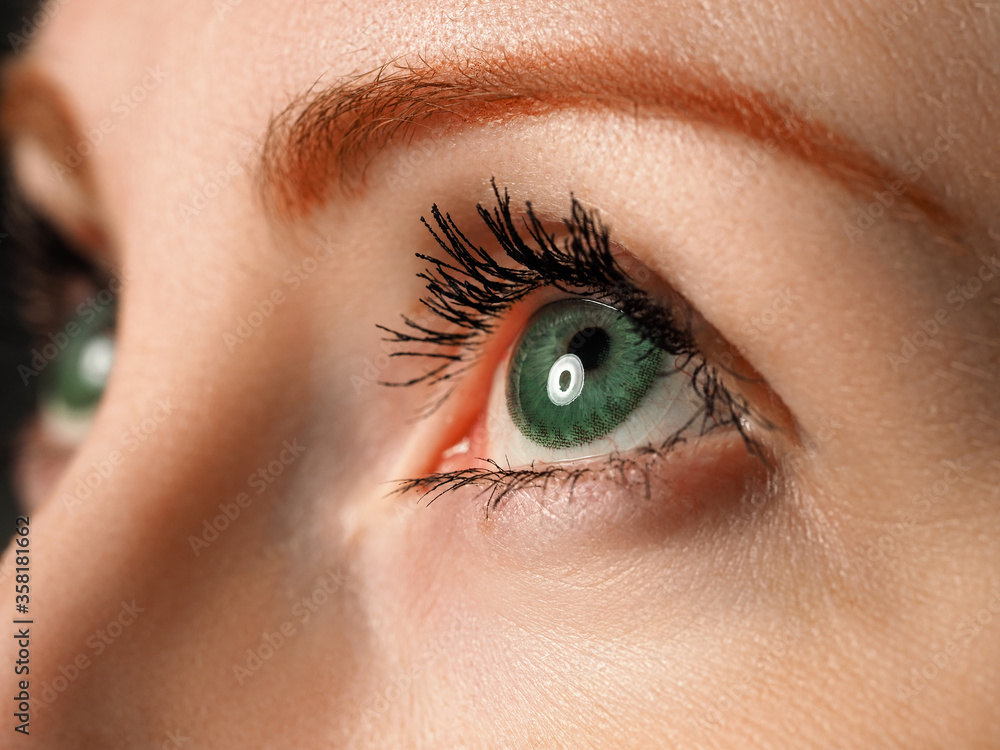 Female left blue eye tinted in green colour with special contact lens Female left blue eye tinted in green colour with special contact lens