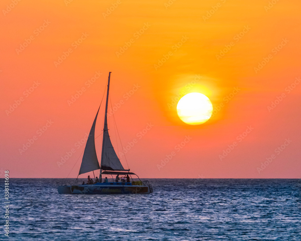 sailboat at sunset in Aruba