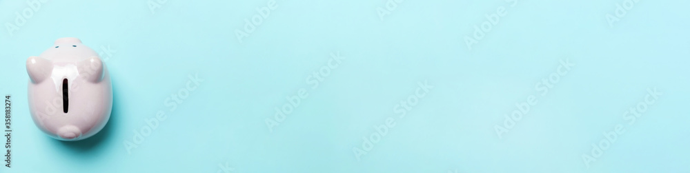 Simply minimal design pink piggy bank isolated on blue pastel background. Saving investment budget wealth business retirement financial money banking concept. Flat lay top view copy space, banner Simply minimal design pink piggy bank isolated on blue pastel background. Saving investment budget wealth business retirement financial money banking concept. Flat lay top view copy space, banner