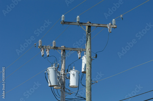 Power lines isolated against blue sky