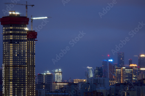 The construction of a high-rise building in the city. Moscow apartments at night. Moscow City. Moscow, Russia.