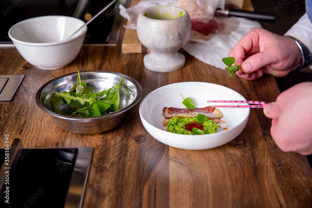 Chef decorates a peas, horse meat and kimchi sauce. Master class in the kitchen. The process of cooking. Step by step. Tutorial. Close-up Chef decorates a peas, horse meat and kimchi sauce. Master class in the kitchen. The process of cooking. Step by step. Tutorial. Close-up