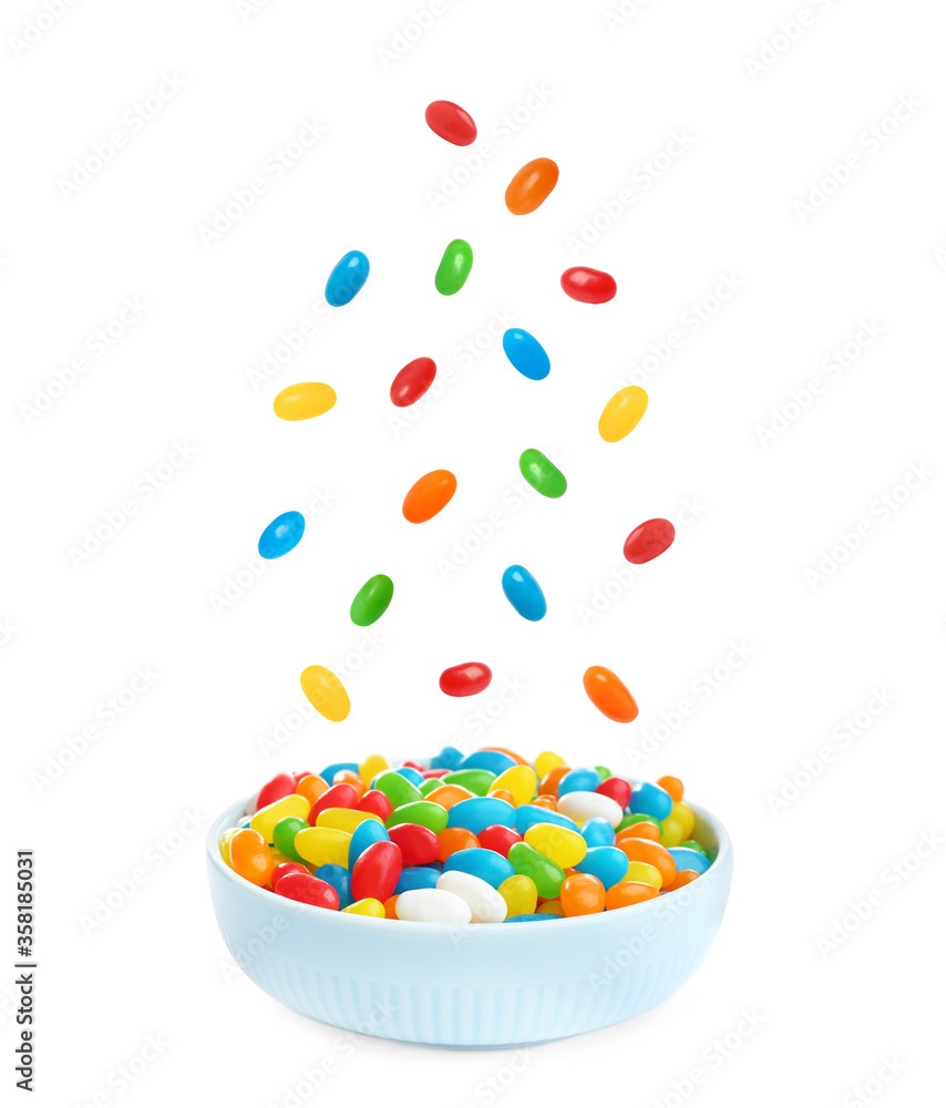Delicious color jelly beans falling into bowl on white background