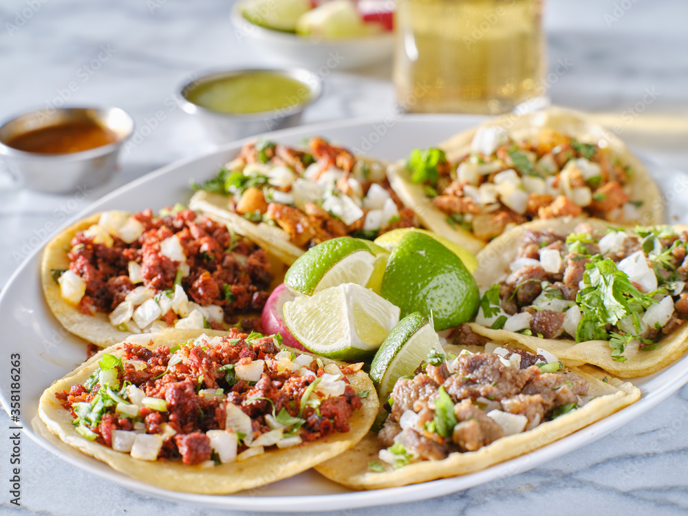 platter of mexican street tacos with carne asada, chorizo, and al pastor in corn tortillas platter of mexican street tacos with carne asada, chorizo, and al pastor in corn tortillas