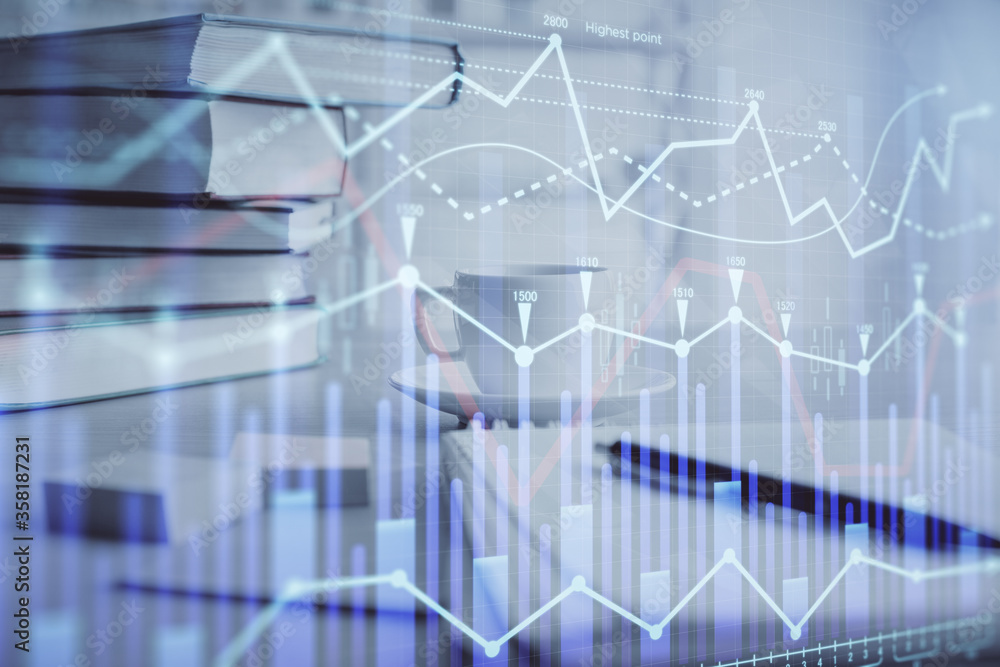 Double exposure of financial chart drawing and desktop with coffee and items on table background. Concept of forex market trading