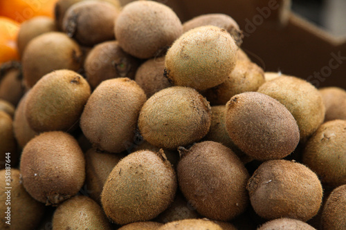 Fresh brown hairy kiwies in the market photo