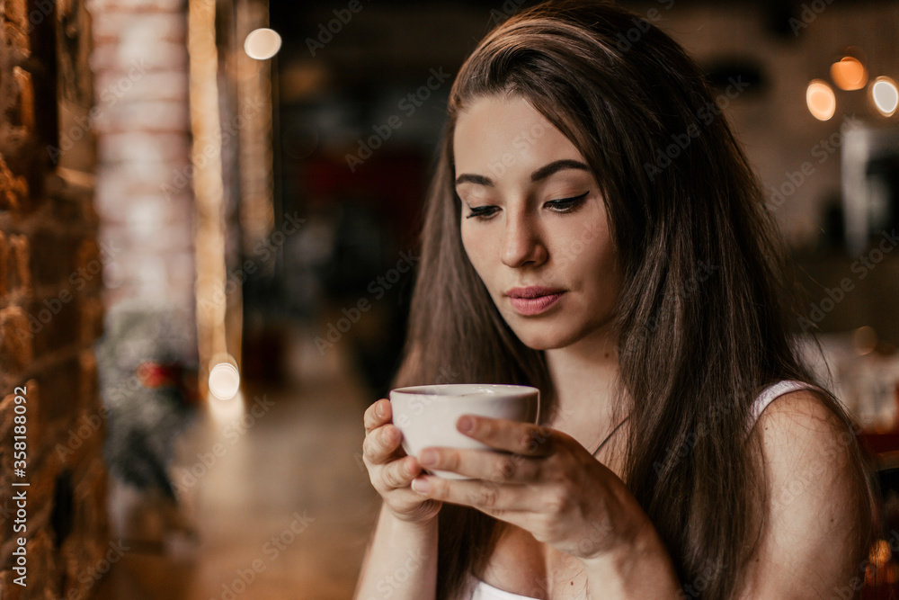 Beautiful woman drinking coffee sitting in a cafe. Beautiful woman drinking coffee sitting in a cafe.