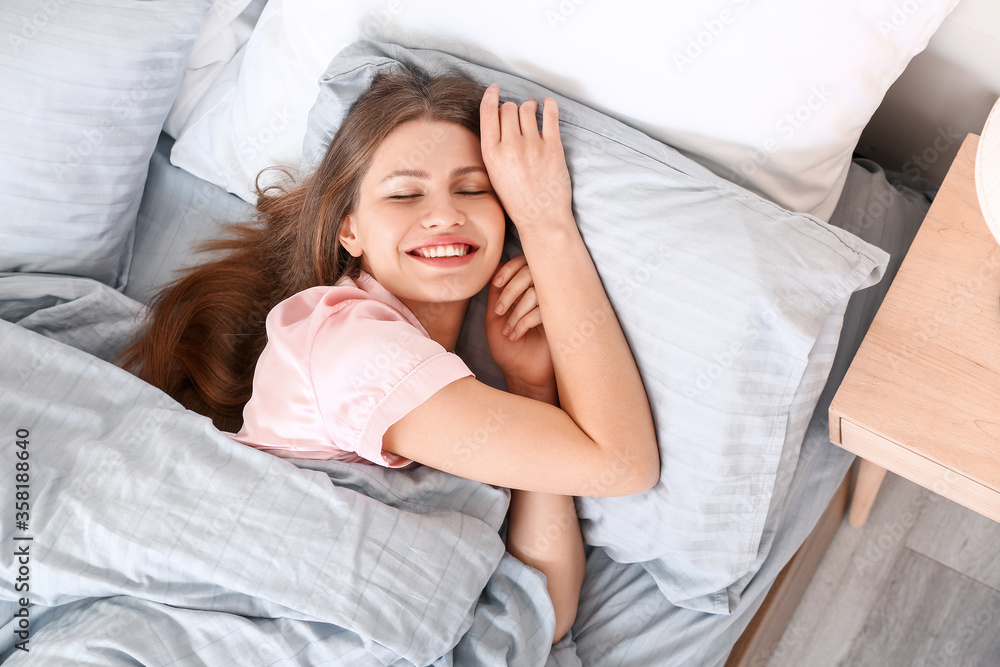 Morning of beautiful young woman lying in bed Morning of beautiful young woman lying in bed