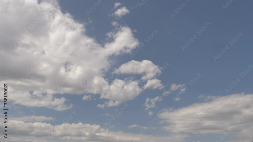 clean timelapse clouds. the sky is blue. white clouds. black rain clouds. residential view. passing cars clean timelapse clouds. the sky is blue. white clouds. black rain clouds. residential view. passing cars