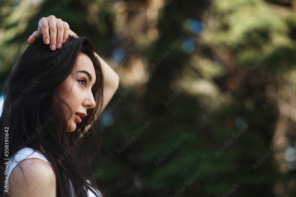 Closeup caucasian woman side face portrait outdoors. Brunette with juicy lips and brown eyes. Profile portrait. Closeup caucasian woman side face portrait outdoors. Brunette with juicy lips and brown eyes. Profile portrait.