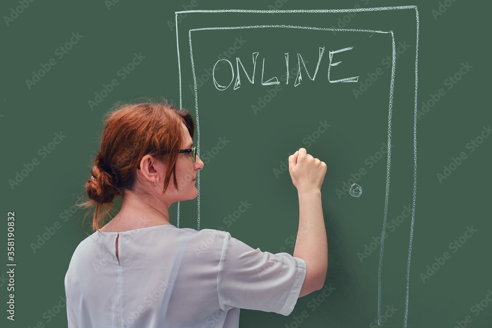 A teacher knocks on the door with online education written on the blackboard. Problems of online learning in quarantine due to the coronavirus epidemic