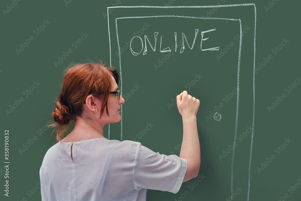 A teacher knocks on the door with online education written on the blackboard. Problems of online learning in quarantine due to the coronavirus epidemic A teacher knocks on the door with online education written on the blackboard. Problems of online learning in quarantine due to the coronavirus epidemic