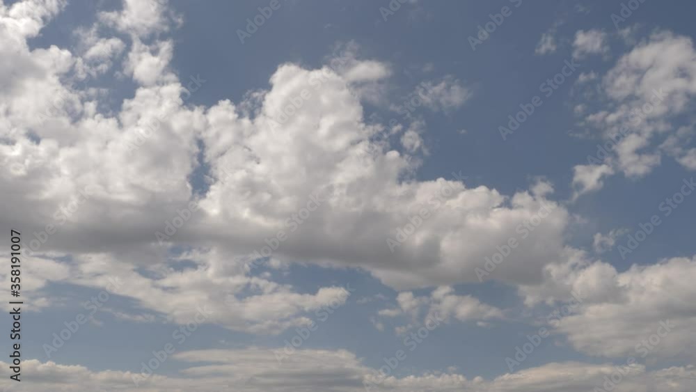 clean timelapse clouds. the sky is blue. white clouds. black rain clouds. residential view. passing cars clean timelapse clouds. the sky is blue. white clouds. black rain clouds. residential view. passing cars