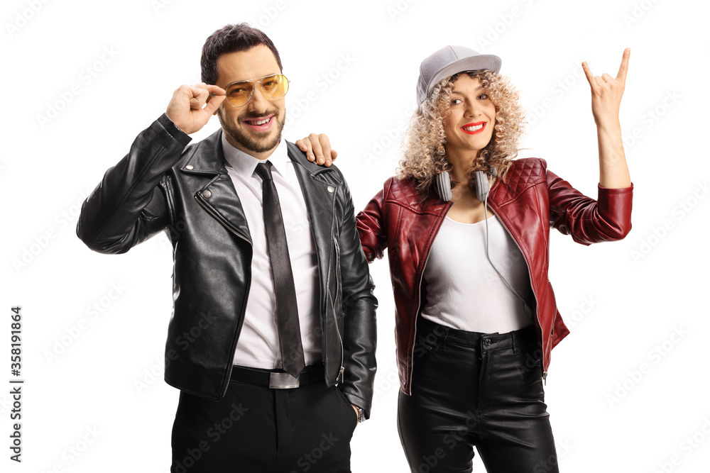 Young couple gesturing a rock and roll sign Young couple gesturing a rock and roll sign