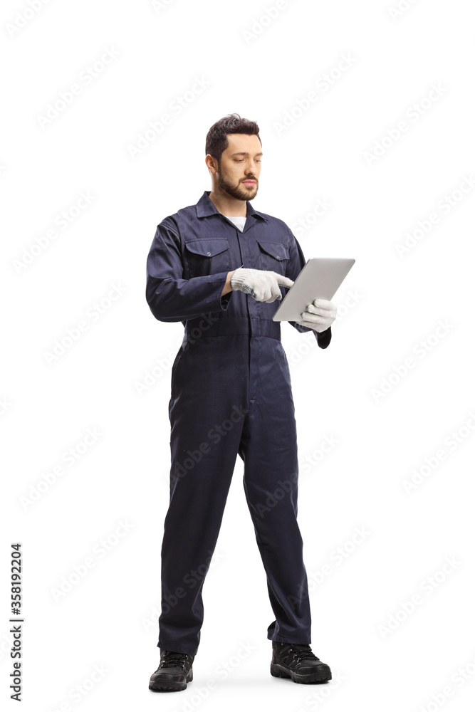 Full length portrait of an auto mechanic using a tablet Full length portrait of an auto mechanic using a tablet