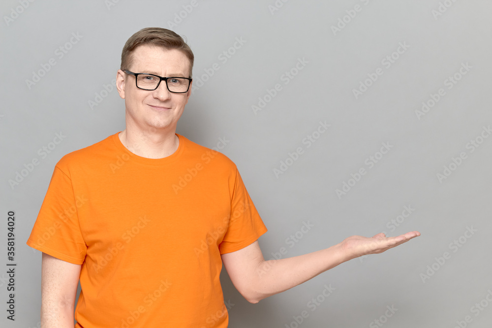 Portrait of happy man showing copy space over open palm and smiling Portrait of happy man showing copy space over open palm and smiling