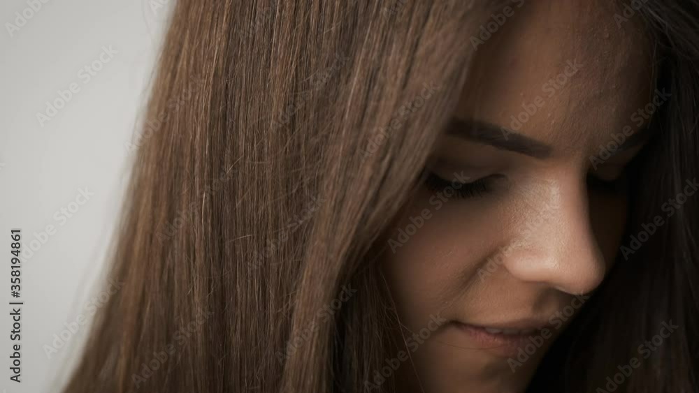 Beautiful girl of Caucasian appearance with long black hair posing for the camera in the studio. A beautiful look in his eyes Beautiful girl of Caucasian appearance with long black hair posing for the camera in the studio. A beautiful look in his eyes