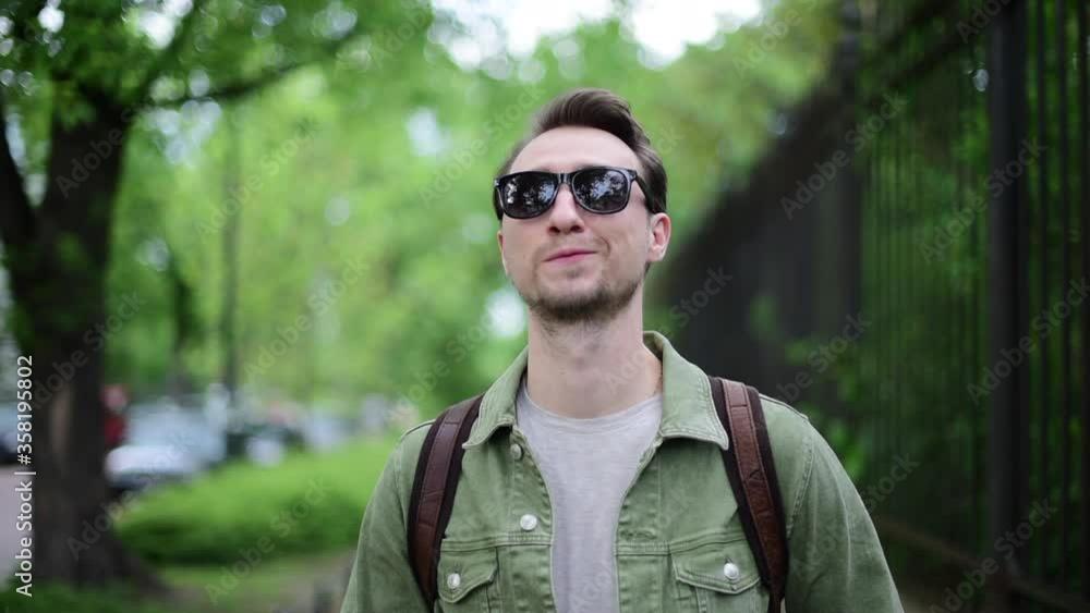 Man flirts looks at camera in sunglasses. Young funny handsome Man flirting sunglasses off and look at camera. Flirt, seduction, temptation concept. Positive people emotions. Man flirts looks at camera in sunglasses. Young funny handsome Man flirting sunglasses off and look at camera. Flirt, seduction, temptation concept. Positive people emotions.