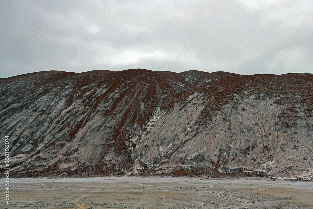 Fototapeta premium Amazing martian landscape, beautiful mountain landscape with salt mountains and sand ground. Salt plantations and salt lakes of the salt industry