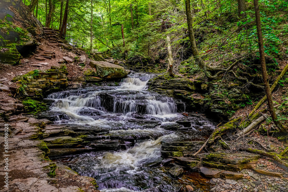Beautiful landscape image of nature and a waterfall at Rickett's Glen State Park in Pennsylvania. Beautiful landscape image of nature and a waterfall at Rickett's Glen State Park in Pennsylvania.