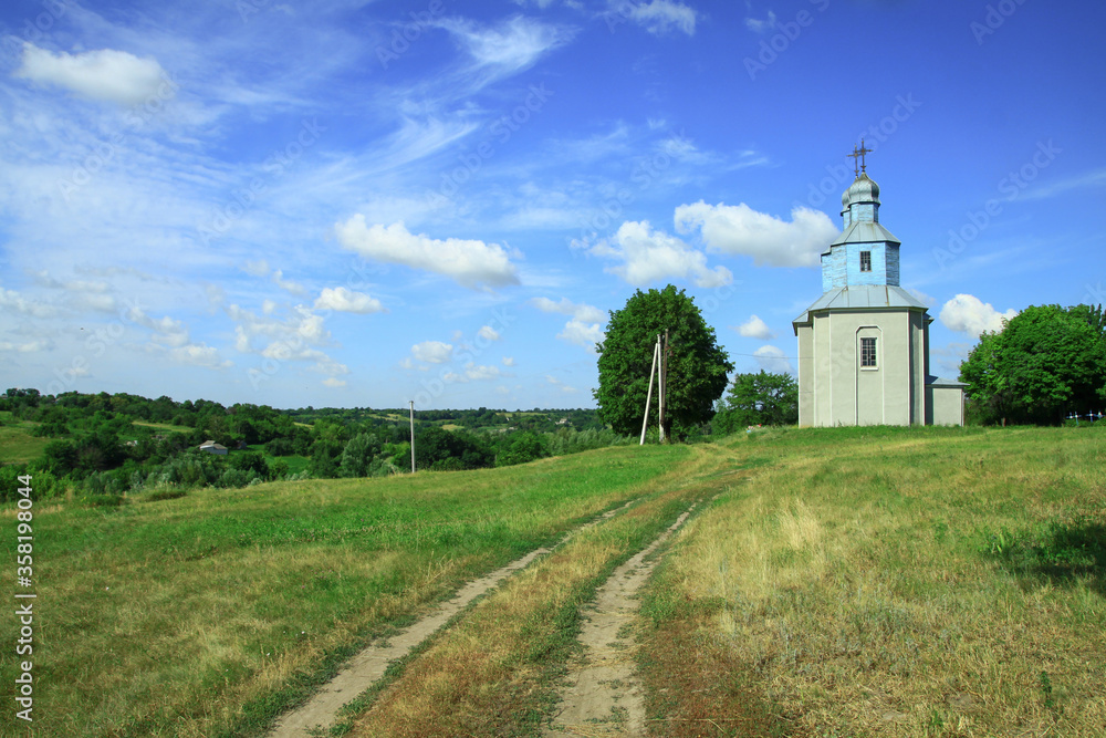 Church on a hill on the outskirts of the village. Christian temple landscape in Russia. Stock photo background