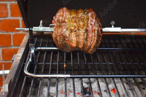 Cooked rotisserie beef on charcoal barbecue The turning action helps hold in the moisture so it doesn't need marinating or basting Simple seasonings like salt and pepper let the meat flavour stand out