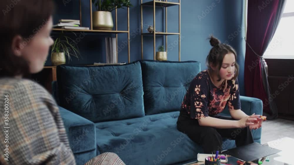 Teenage girl having therapy with a child psychologist. Young girl doing test with plasticine and talking with her psychologist