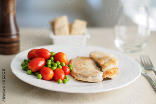 chicken filet with cherry tomatoes and peas