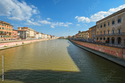 View of both sides of the Arno River near the historic center of the Tuscan city of Pisa, Italy