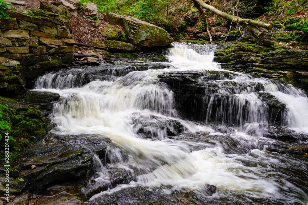 Cascading waterfall going multiple ways. down stream. Rickett's Glen State Park in Pennsylvania. Cascading waterfall going multiple ways. down stream. Rickett's Glen State Park in Pennsylvania.