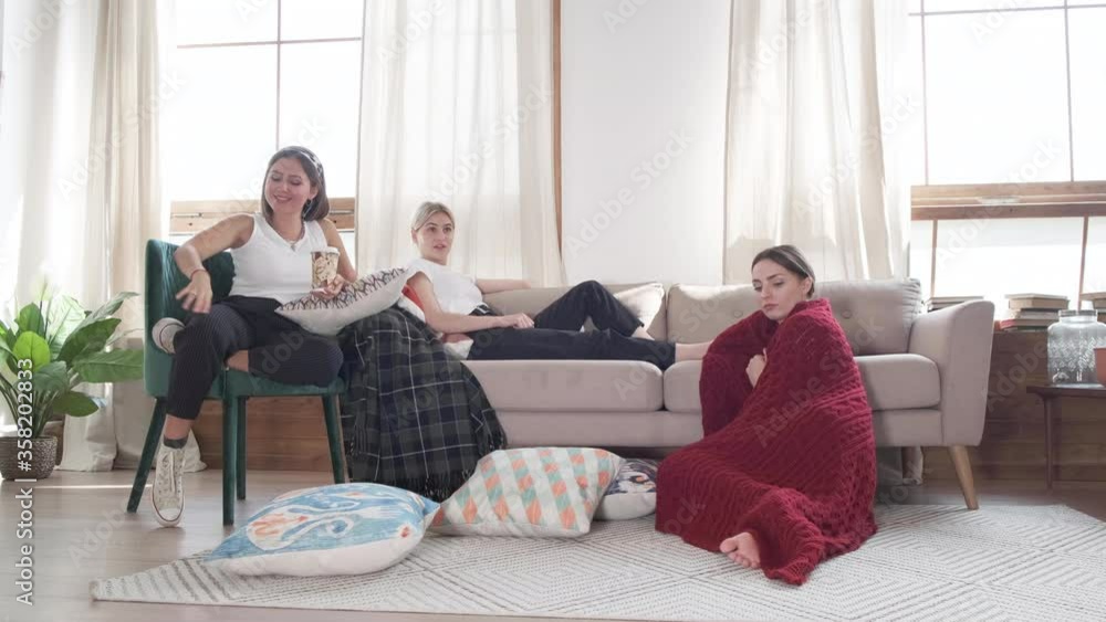 Three caucasian girlfriends sitting in home. Young women relaxing. Three caucasian girlfriends sitting in home. Young women relaxing.