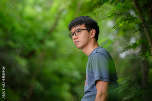 portrait of a handsome young man in the park © praderm