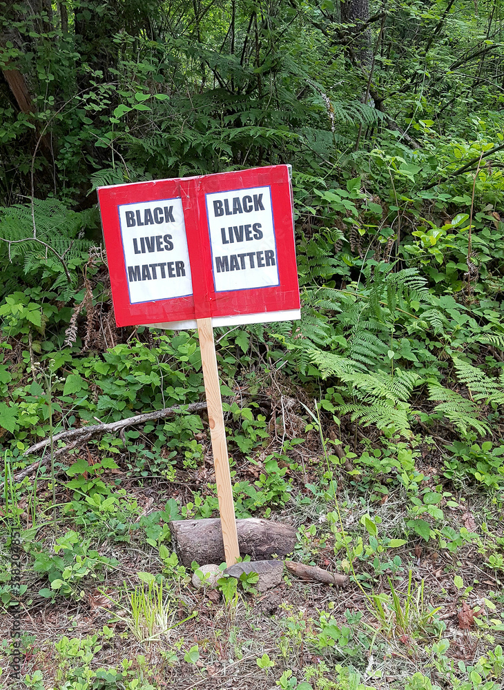 Black Lives Matter sign posted at a cross road. Black Lives Matter sign posted at a cross road.