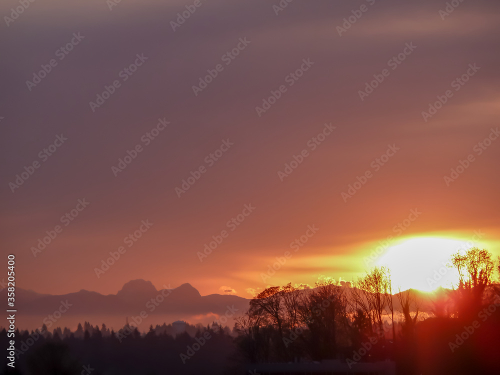 Violet sky and bright sunrise over Cascade Mountain Range in Washington State.