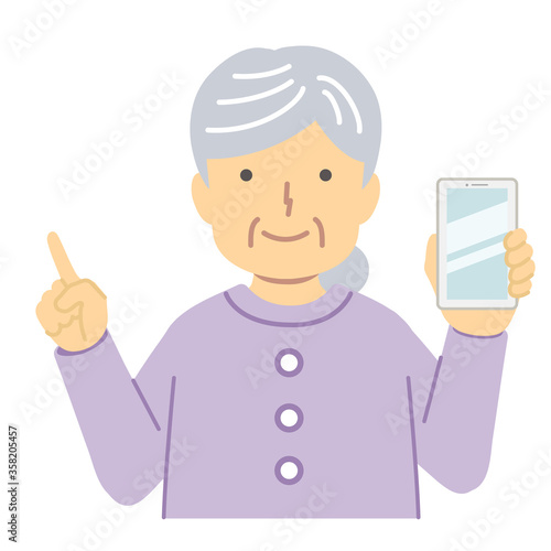 紫の服を着たシニア女性/指差し