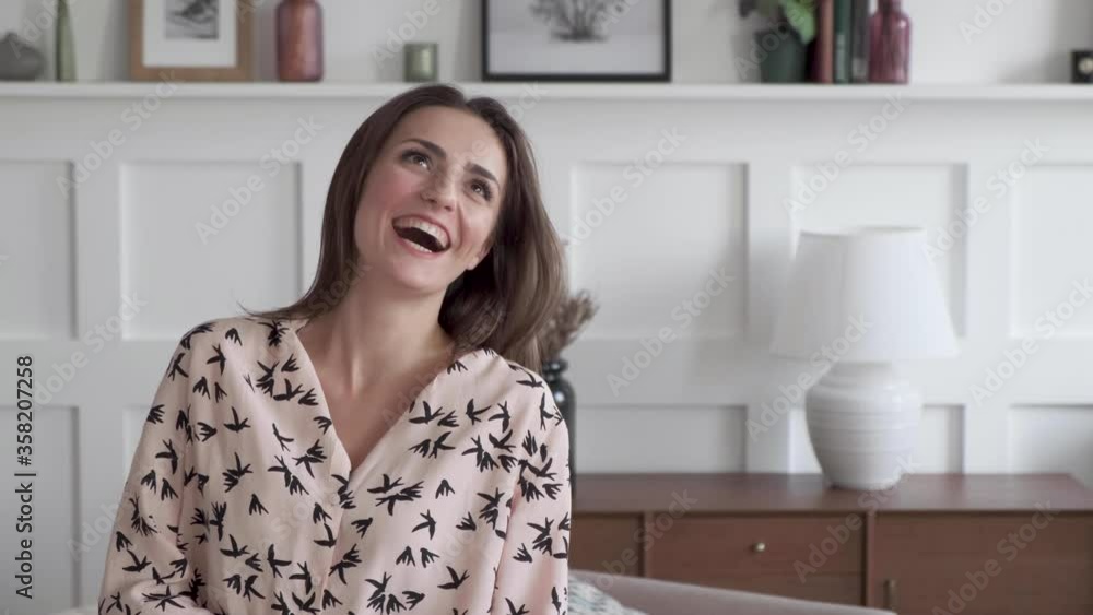 Close-up portrait of brunette brown-eyed caucasian woman smiling at camera. Charming young girl posing at home. Leisure. Close-up portrait of brunette brown-eyed caucasian woman smiling at camera. Charming young girl posing at home. Leisure.