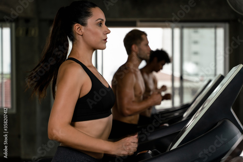 athlete woman workout with trade mill in fitness gym and health club