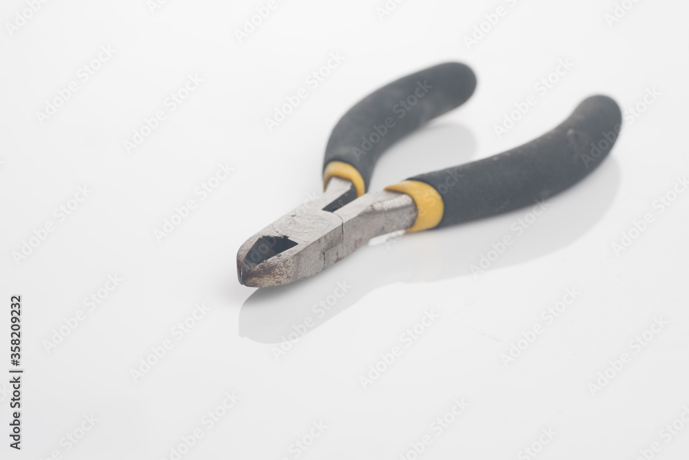 A wire cutter ,isolated over white reflective background