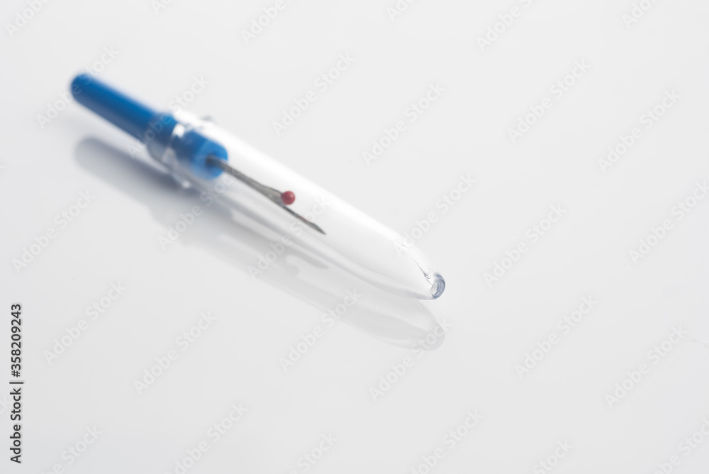 seam ripper isolated over white reflective background seam ripper isolated over white reflective background