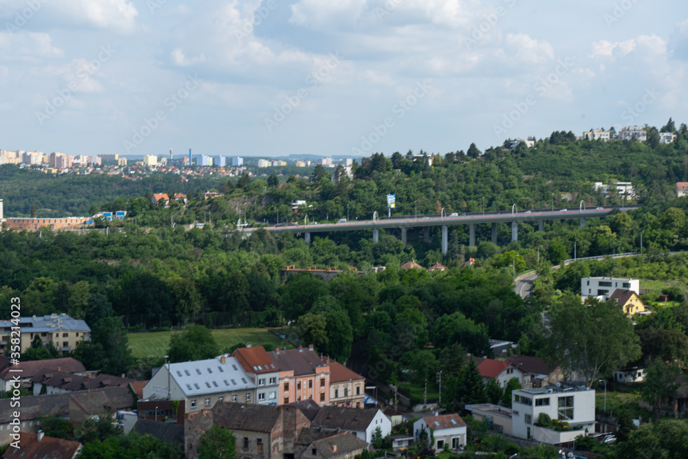 
view of the Czech countryside near Prague and buildings in the background and tracks and a viaduct for trains