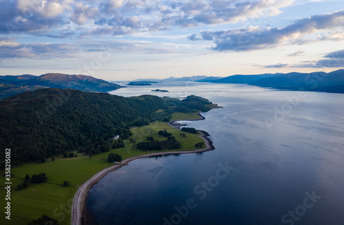 aerial image of loch linnhe on the west coast of the argyll and lochaber region of scotland near kentallen and duror showing calm blue waters and clear skies with green forest coast line