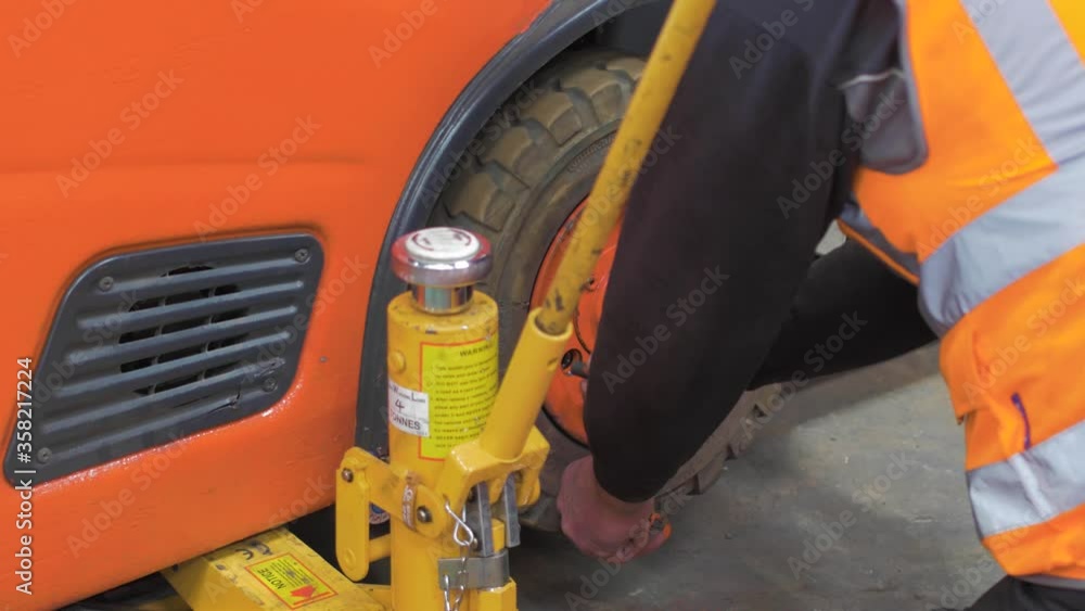 Fitting a tyre in a garage using, checking the threading Fitting a tyre in a garage using, checking the threading