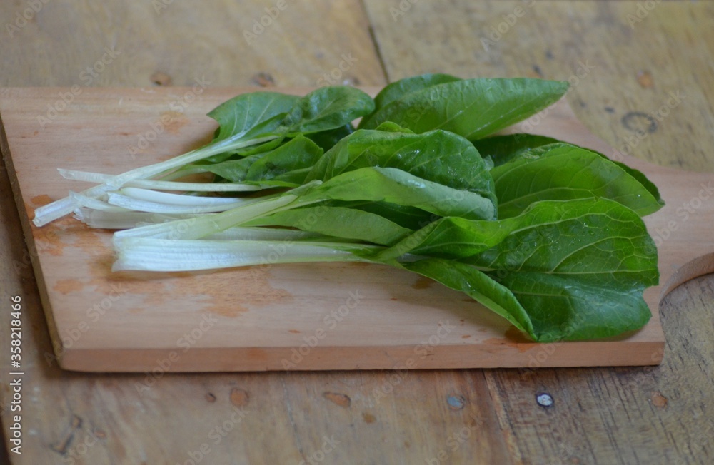 fresh pakchoi cabbage on a chopping board fresh pakchoi cabbage on a chopping board