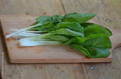 fresh pakchoi cabbage on a chopping board