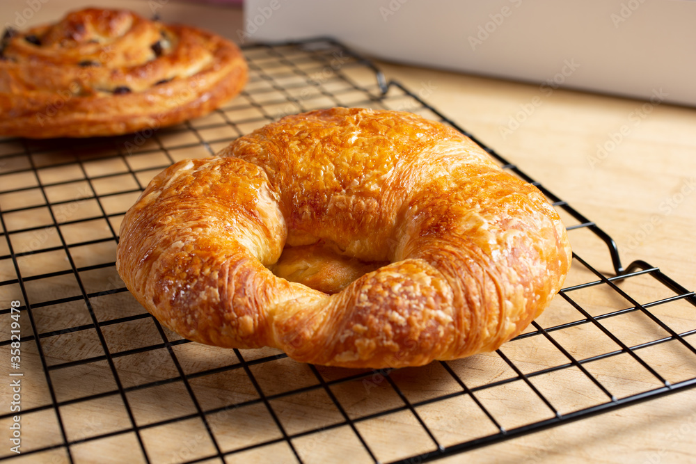 A closeup view of a croissant, in a still life setting. A closeup view of a croissant, in a still life setting.