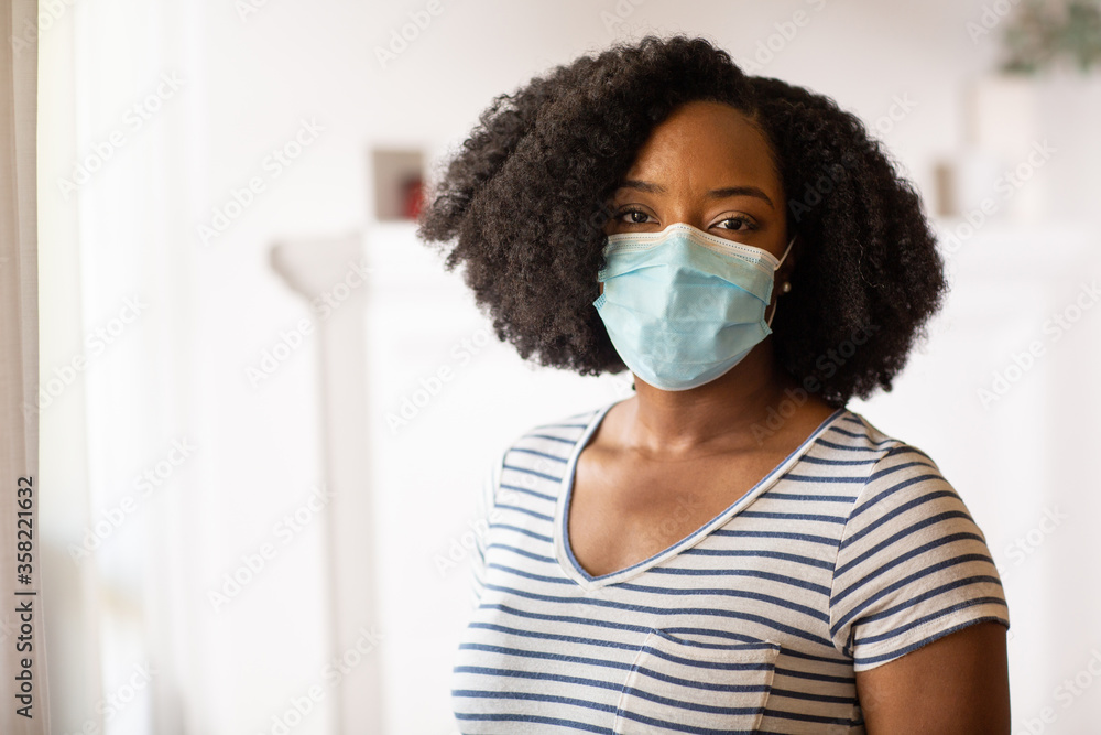Close up view of an African American woman wearing a face mask Close up view of an African American woman wearing a face mask