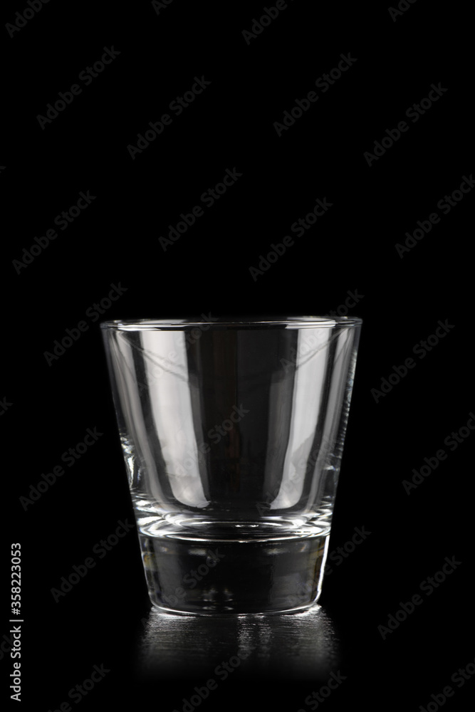 Glass for alcoholic drinks on black - obrazy, fototapety, plakaty 