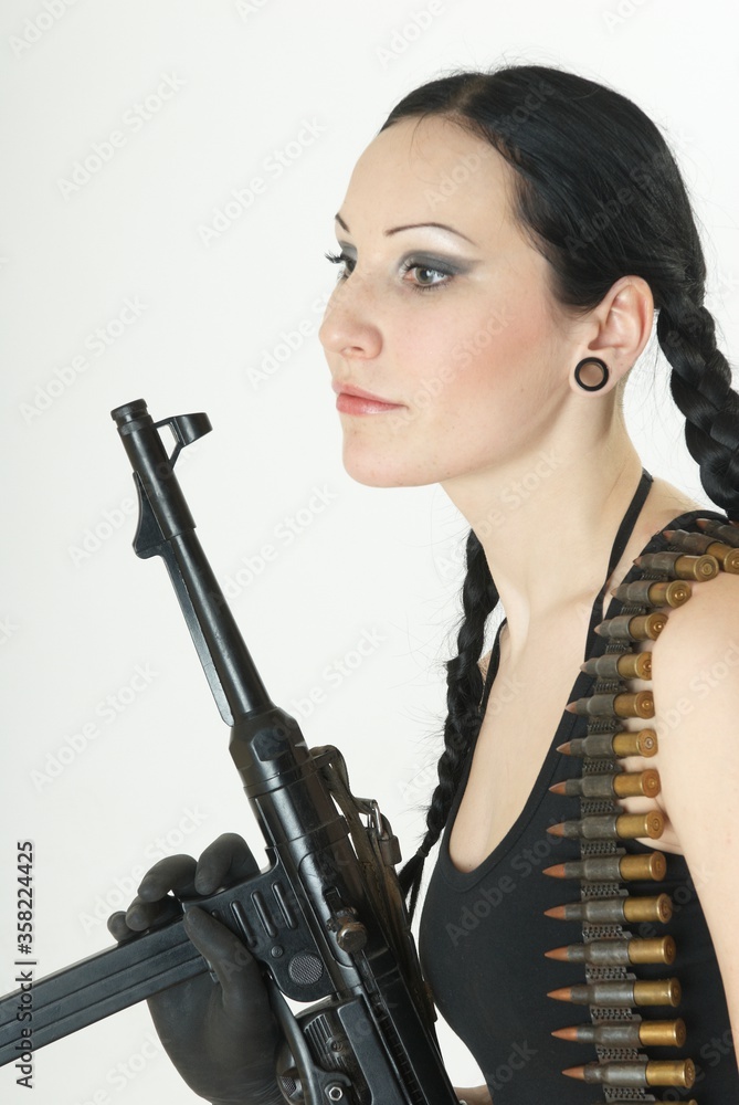 White girl dressed in black with shotgun and bullets. White girl dressed in black with shotgun and bullets.